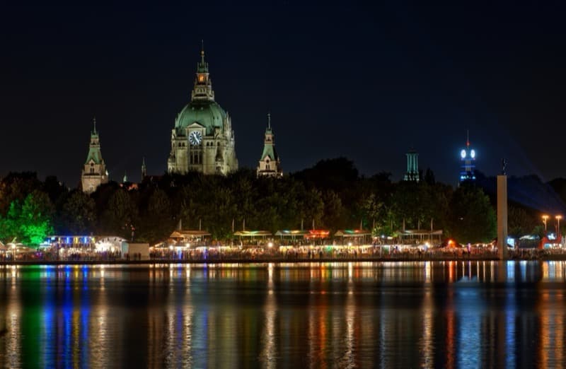 Hanover's New Town Hall at night with the illuminated Maschseefest reflected in the lake.