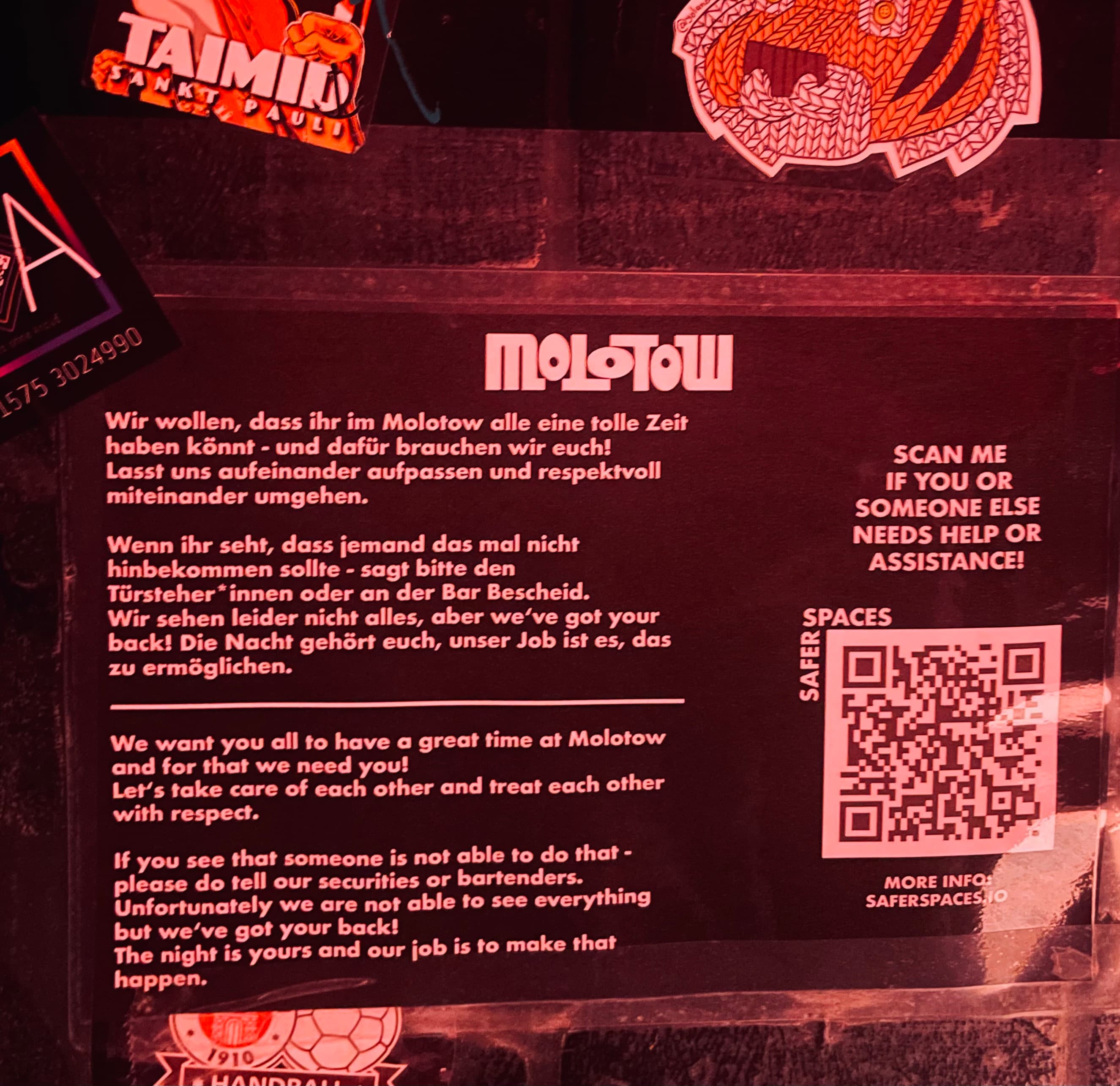 Awareness poster inside Hamburg's Molotow club featuring a saferspaces QR code.