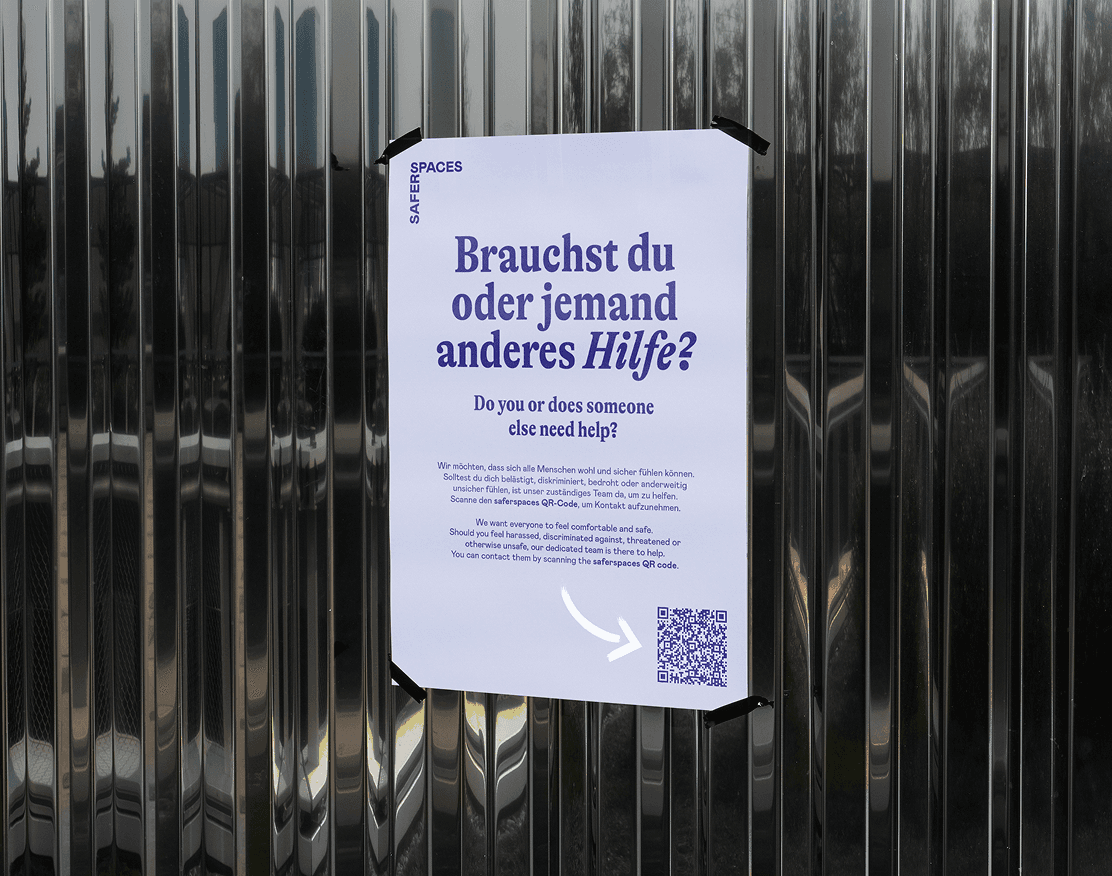 Poster on a metal wall with text: 'Do you or does someone else need help?' and QR code on the bottom right.